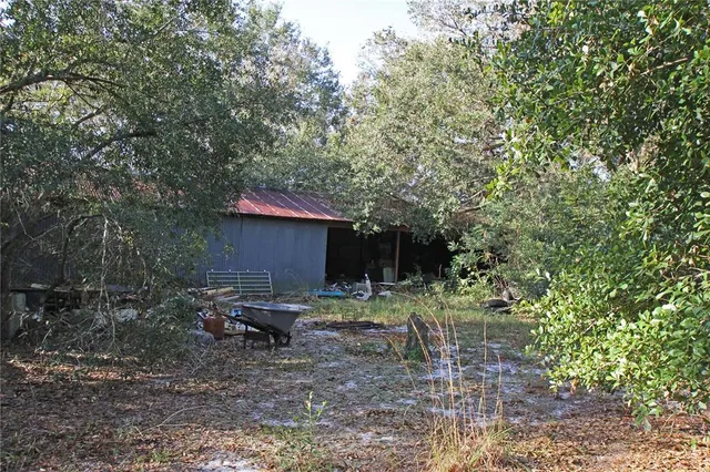 a backyard of a house with table and chairs