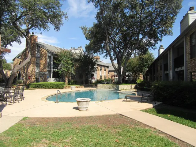 a view of a swimming pool with a patio