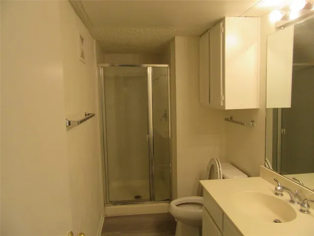 a bathroom with a sink toilet and shower