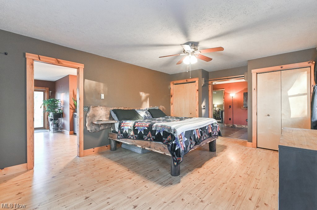 4802 Beach Road Medina, OH 44256 - Photo 18 of 35 Bedroom featuring a textured ceiling, ceiling fan, and light hardwood / wood-style flooring