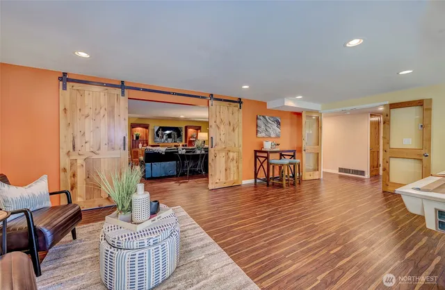 a living room with furniture and wooden floor