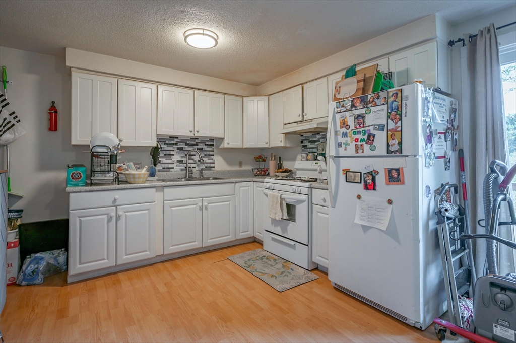 11 Shawnee Road Pepperell, MA 01463 - Photo 12 of 22 a kitchen with stainless steel appliances a refrigerator sink and cabinets