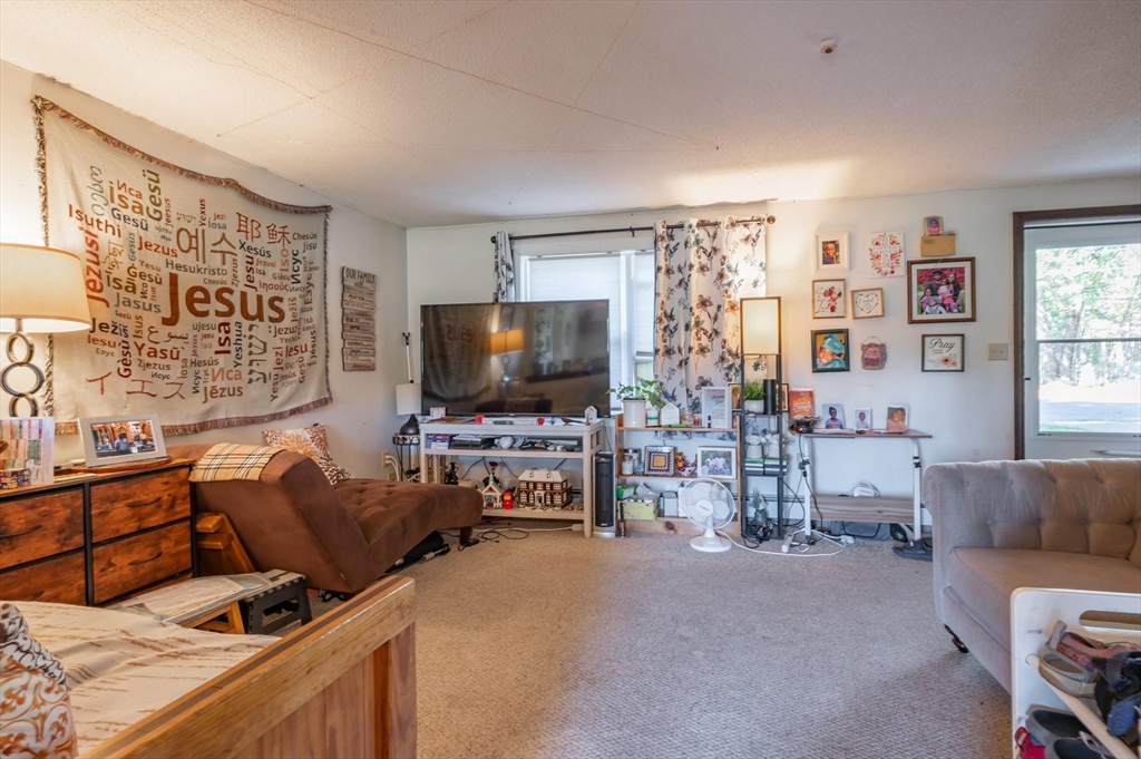 11 Shawnee Road Pepperell, MA 01463 - Photo 14 of 22 a living room with furniture and a flat screen tv