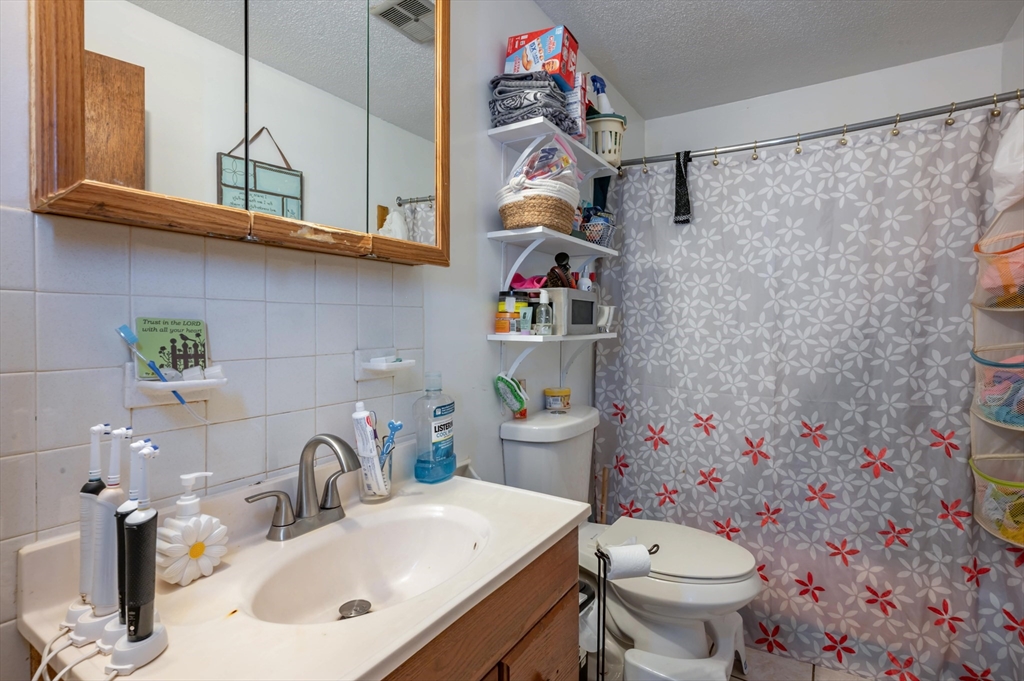 11 Shawnee Road Pepperell, MA 01463 - Photo 16 of 22 a bathroom with a sink a toilet and vanity