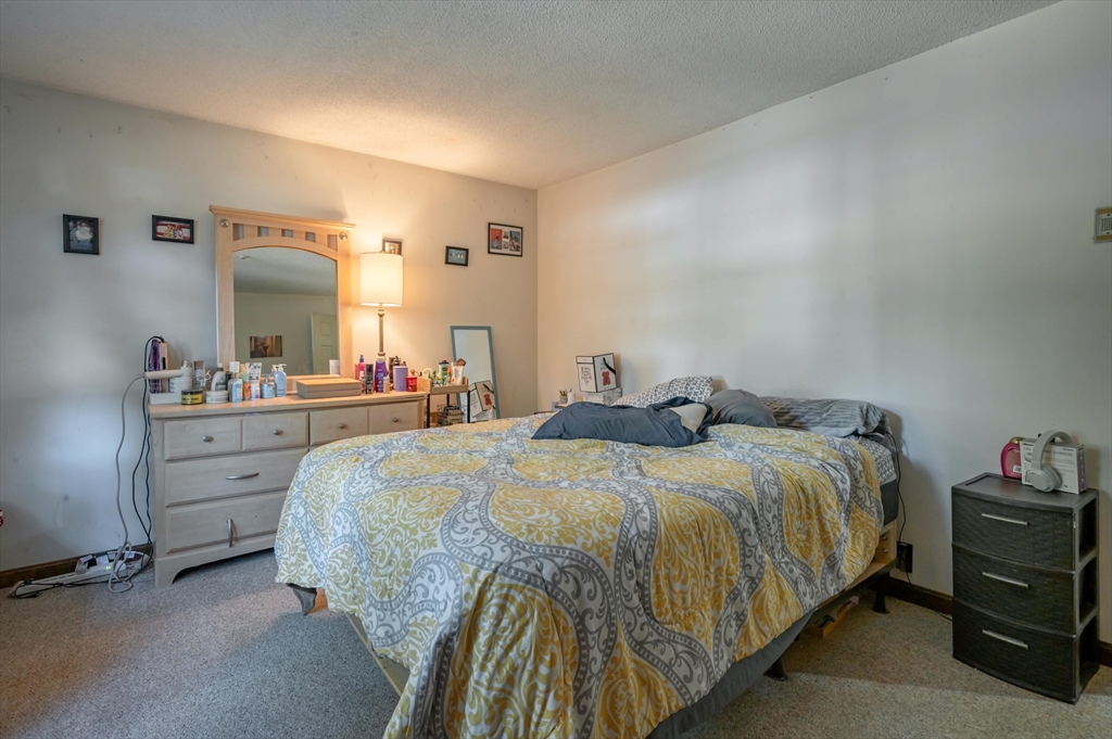 11 Shawnee Road Pepperell, MA 01463 - Photo 8 of 22 a spacious bedroom with a bed and a dresser