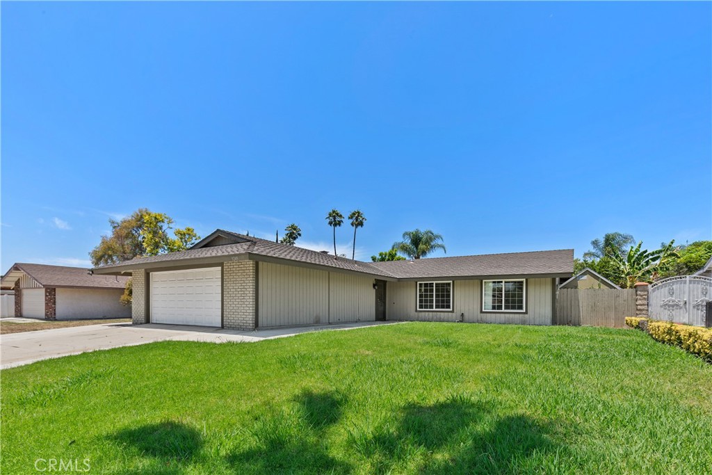 9249 Delano Drive Riverside, CA 92503 - Photo 1 of 1 a front view of a house with a garden