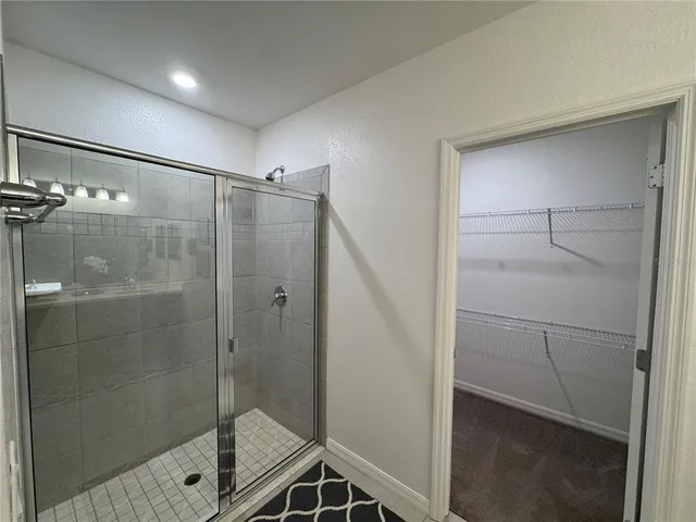 a bathroom with a shower and a glass door