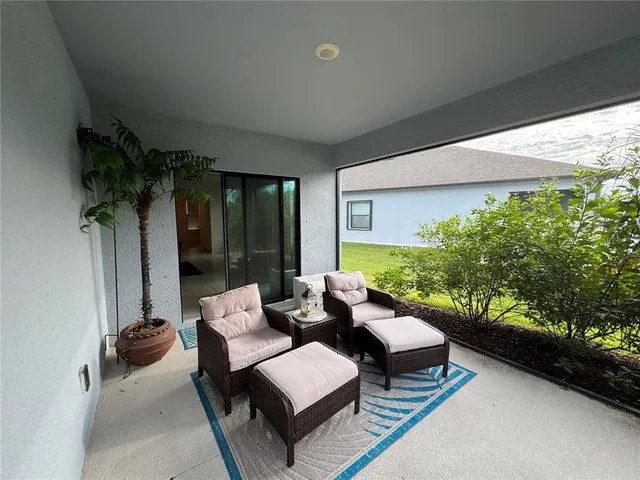 a balcony with furniture and a potted plant