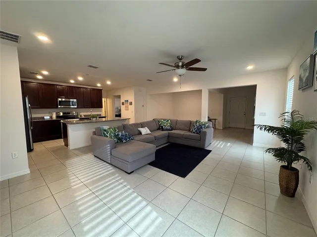 a large white kitchen with a sink and cabinets