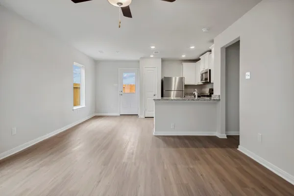 a view of kitchen with wooden floor and electronic appliances