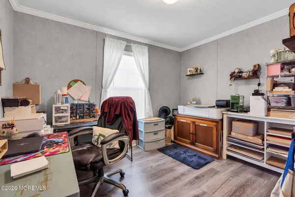 a view of room with guitars and wooden floor