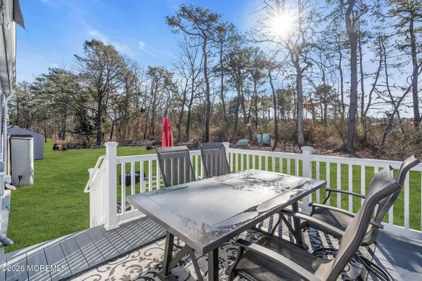 a view of a dinning table and chairs on the deck
