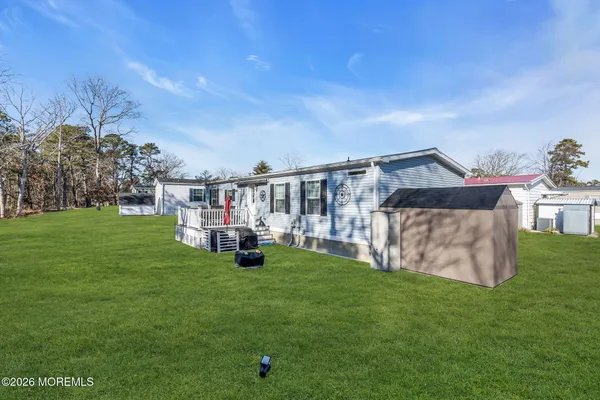 a view of a house with a yard and sitting area