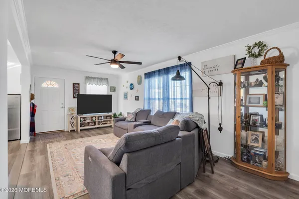 a living room with furniture a flat screen tv and a large window
