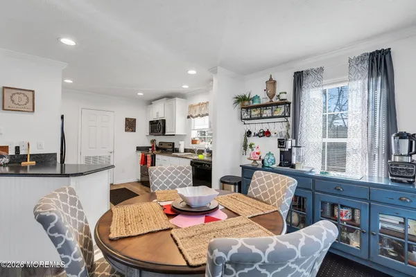 a living room with furniture and kitchen view