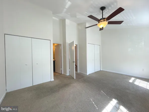 a view of a chandelier fan and a ceiling fan in a room