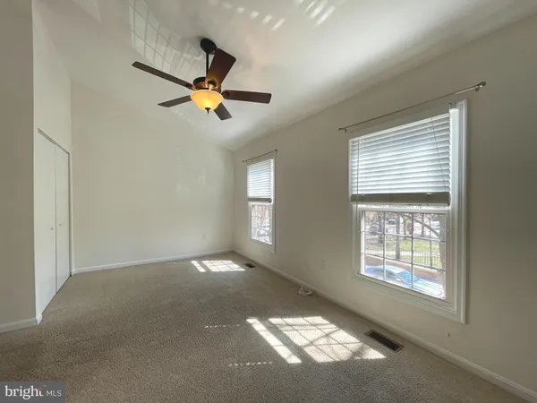 a view of an empty room with windows