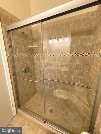 a bathroom with a glass shower door