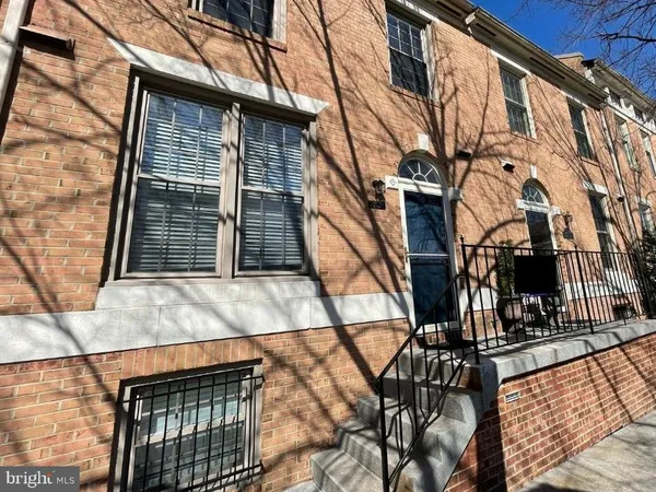 a view of a brick house with many windows
