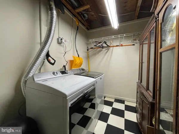 a storage and utility room with a black white checkered floor