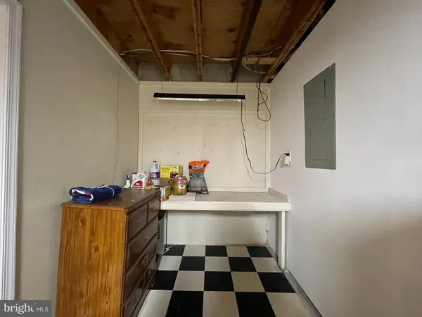 a room with a baby crib and a dresser