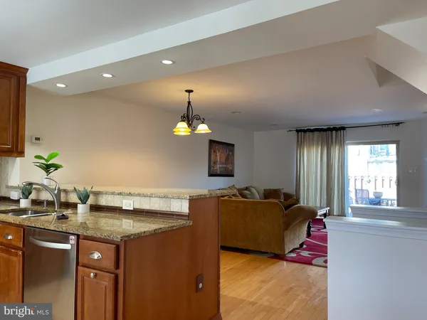 a living room with granite countertop furniture and flat screen tv
