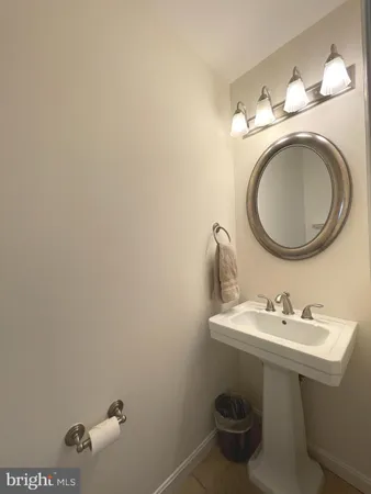 a bathroom with a sink mirror and toilet