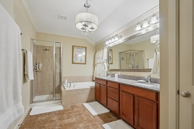a spacious bathroom with a granite countertop sink a toilet a mirror and shower