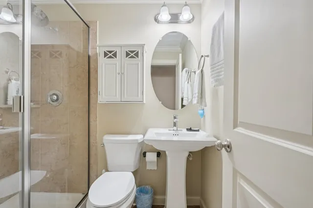 a bathroom with a sink mirror toilet and shower
