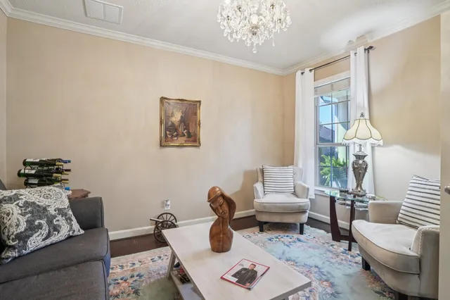 a living room with furniture and a chandelier