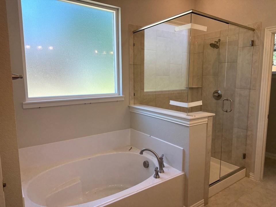 404 Guadalupe Lane Springtown, TX 76082 - Photo 7 of 9 a bathroom with a bathtub and a shower