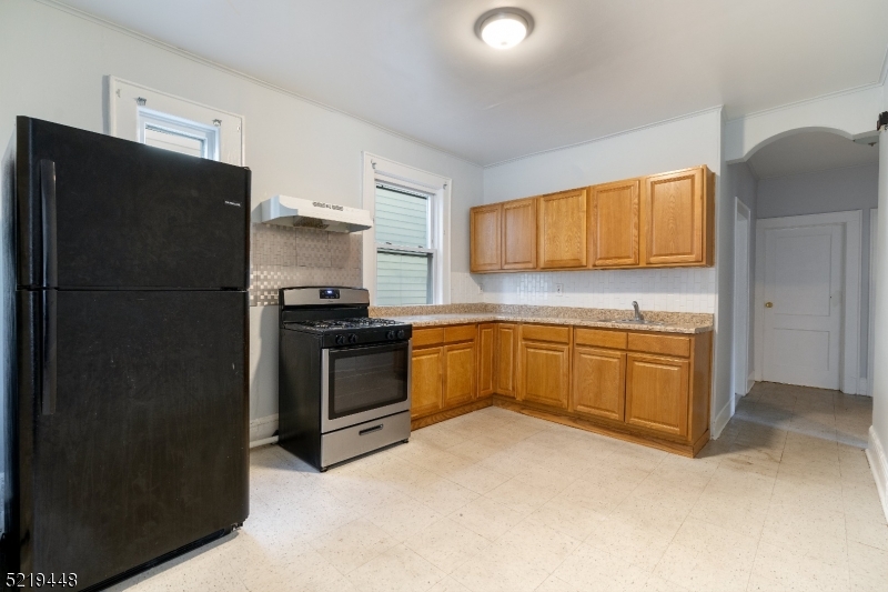 148 Lyons Avenue, Unit 1 Newark, NJ 07112 - Photo 8 of 9 a kitchen with a refrigerator sink and stove