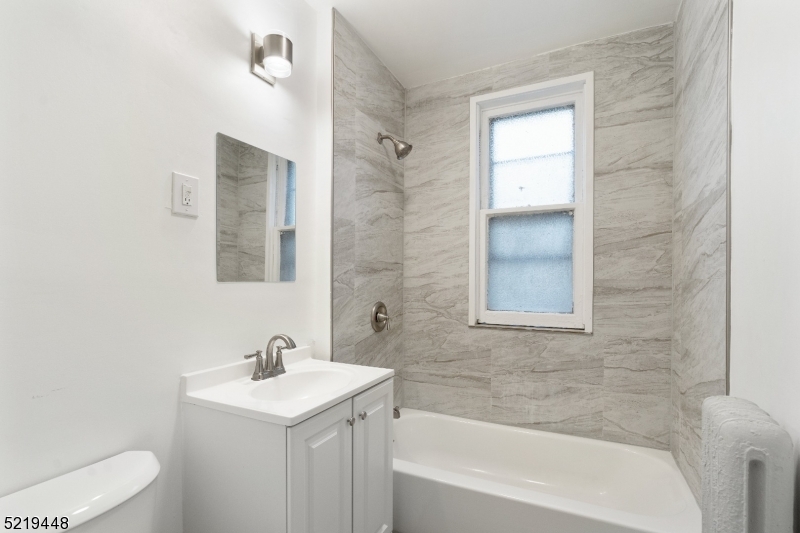148 Lyons Avenue, Unit 1 Newark, NJ 07112 - Photo 9 of 9 a bathroom with a sink toilet and shower