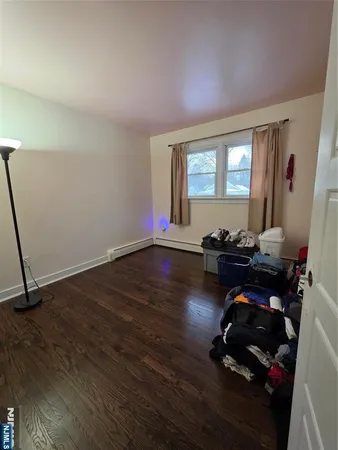 a room with wooden floor and gym equipment