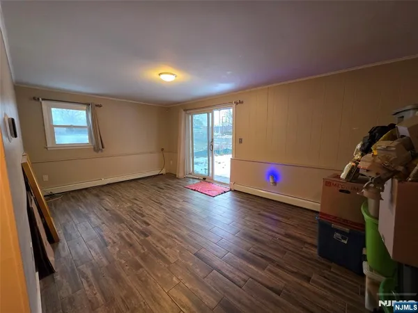 a room with wooden floor and window