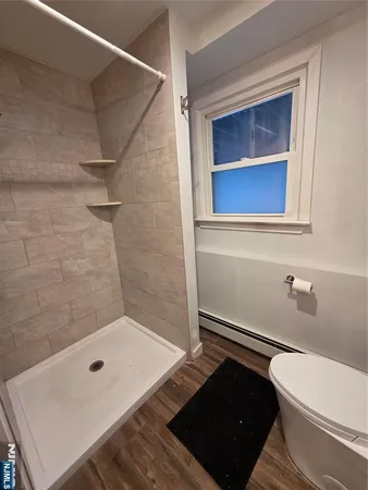 a bathroom with a toilet and a shower