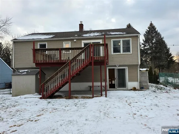 a view of a house with a wooden fence