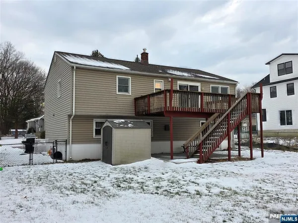 a front view of a house with a wooden deck