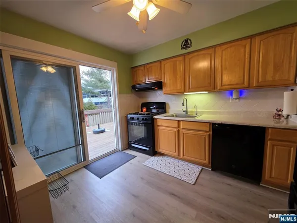 a kitchen with granite countertop wooden floors and stainless steel appliances