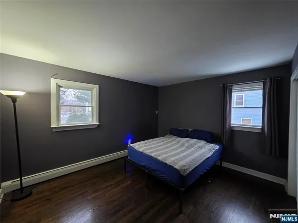 a wooden bench sitting in a bedroom next to a window