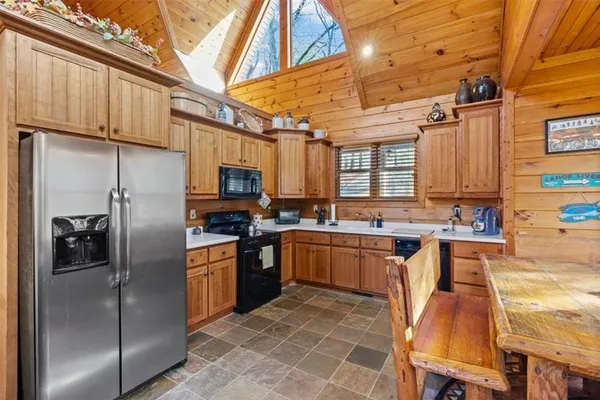 a dining room with furniture a fireplace and wooden floor