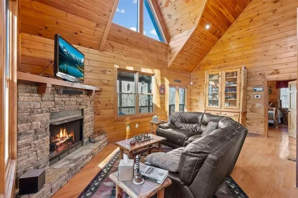 a living room with furniture a fireplace and a flat screen tv