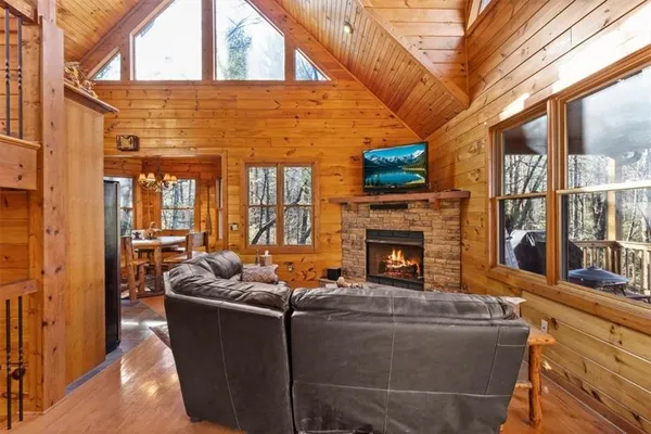 a living room with furniture a fireplace and a flat screen tv