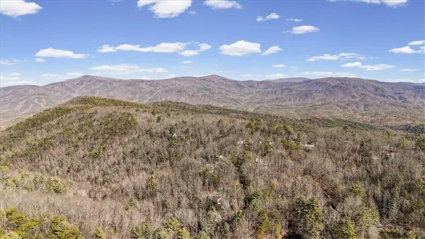 a view of a porch with wooden floor and furniture