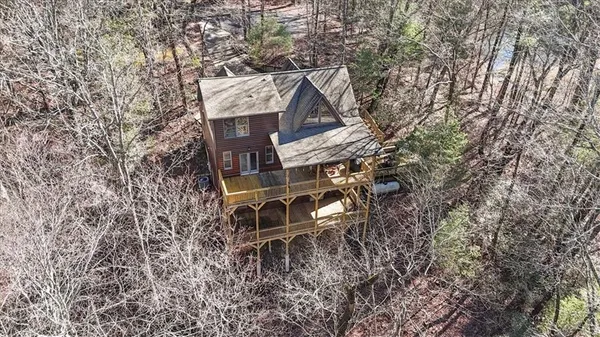 an aerial view of a house with a yard