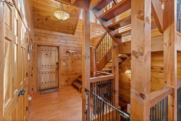 a living room with couches a fireplace with wooden floor