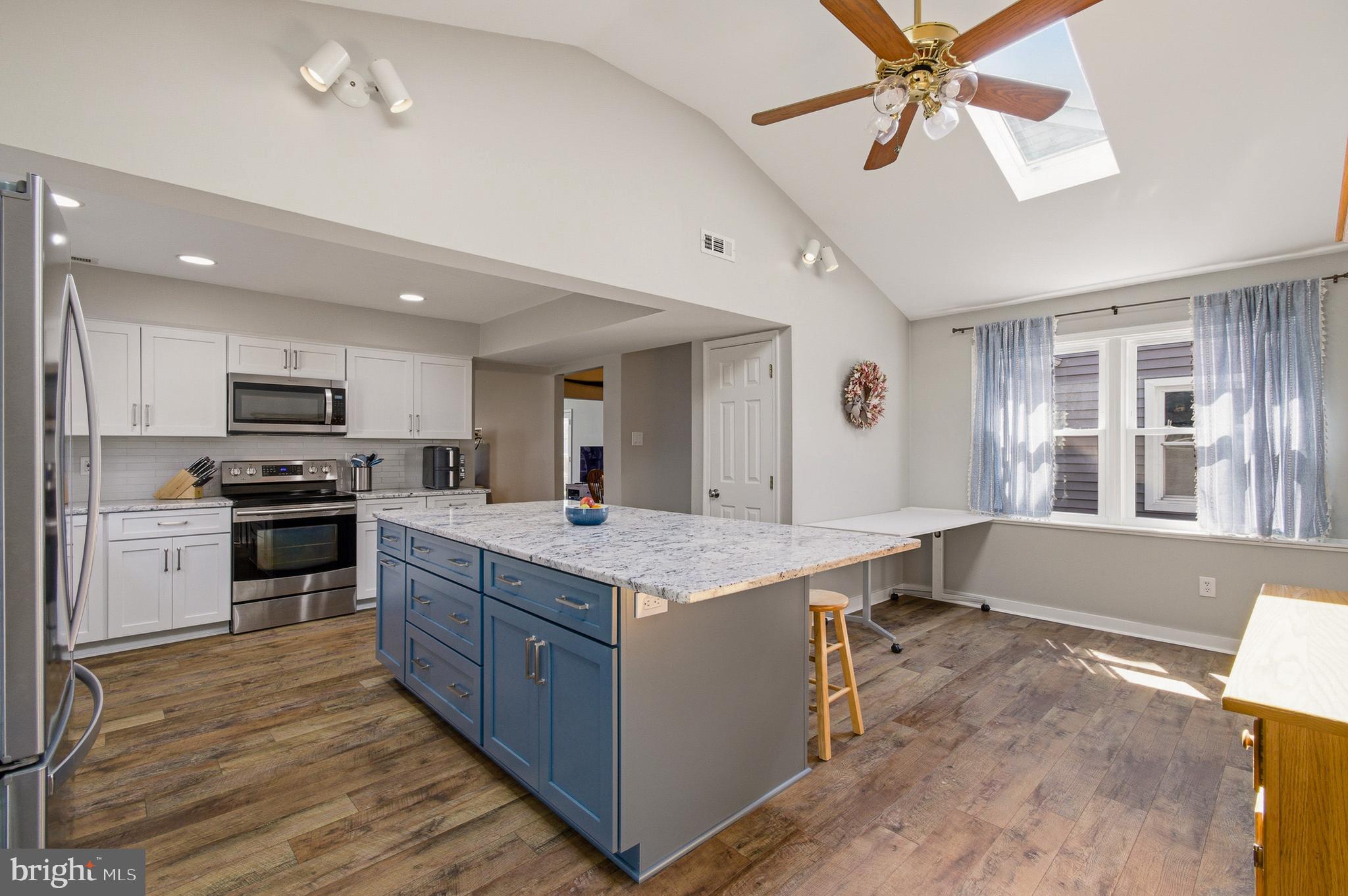 1410 Knights Bridge Turn Crofton, MD 21114 - Photo 11 of 75 a kitchen with stainless steel appliances granite countertop a stove and a sink