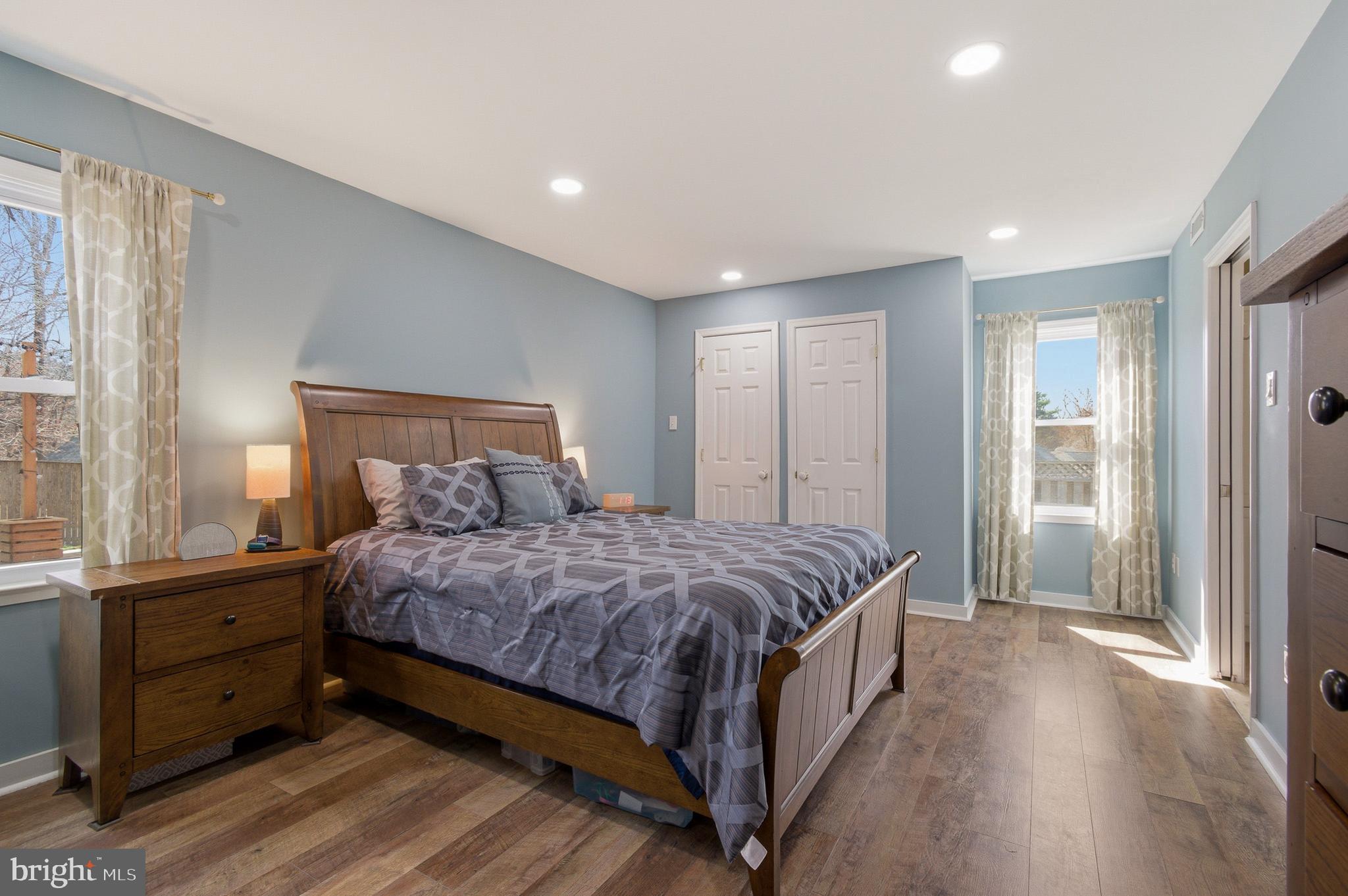 1410 Knights Bridge Turn Crofton, MD 21114 - Photo 33 of 75 a large bedroom with a bed and wooden floor