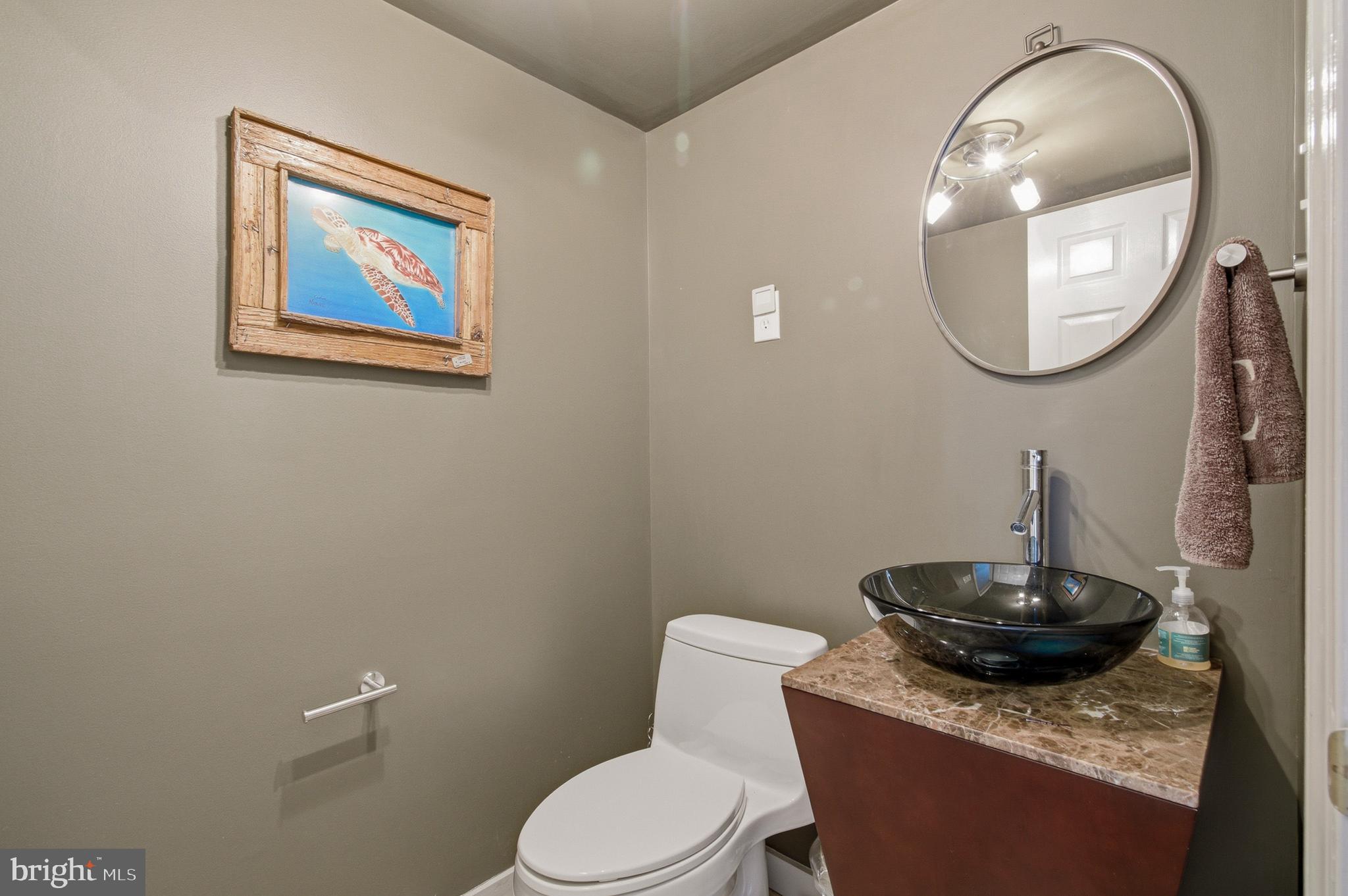 1410 Knights Bridge Turn Crofton, MD 21114 - Photo 44 of 75 a bathroom with a toilet a sink and a mirror