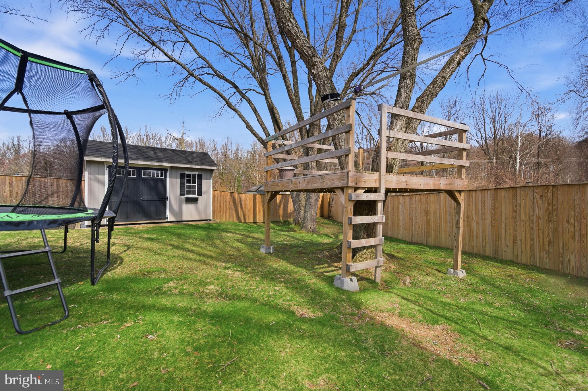 1410 Knights Bridge Turn Crofton, MD 21114 - Photo 52 of 75 a backyard of a house with lots of green space and wooden fence